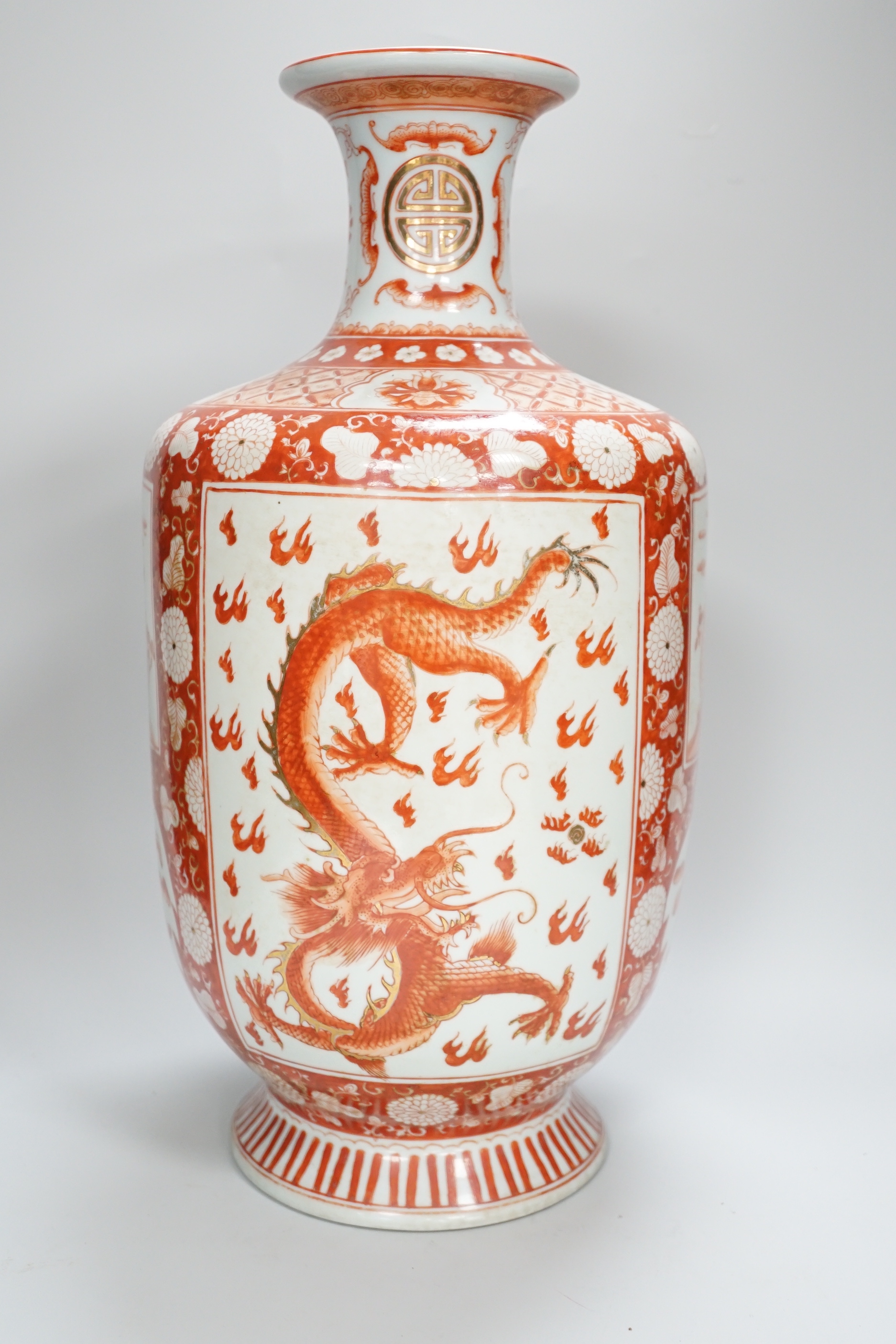 A Chinese iron red decorated ‘Dragon’ vase, a similar smaller pair of ‘Buddhist lion’ vases and a pair of black ground ‘goldfish’ vases, Republic period and later, tallest 42cm high